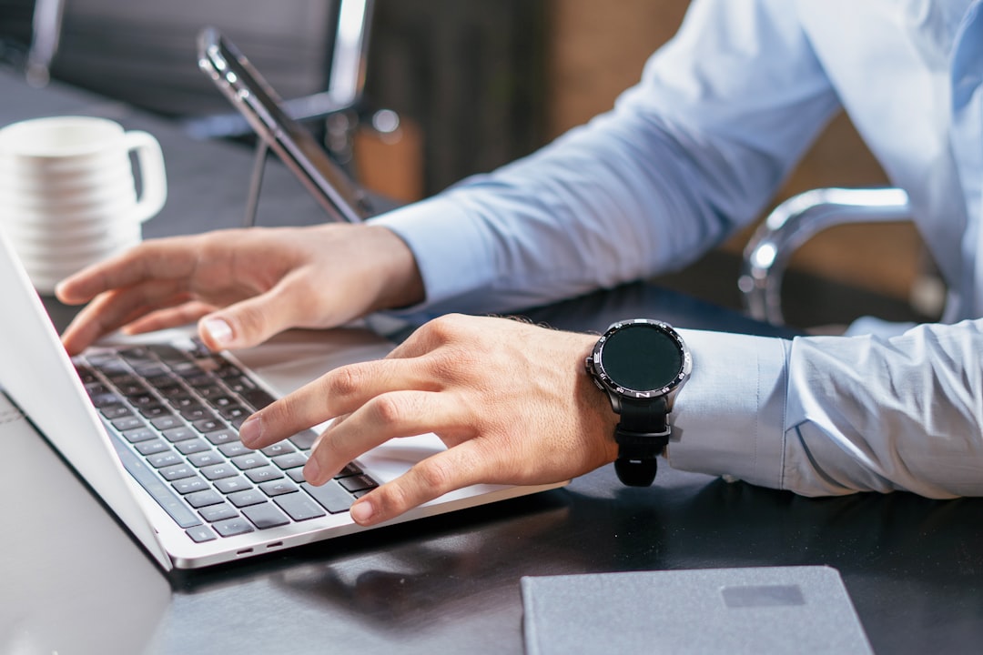 Person using a laptop at a desk for customer inquiry and follow-up work